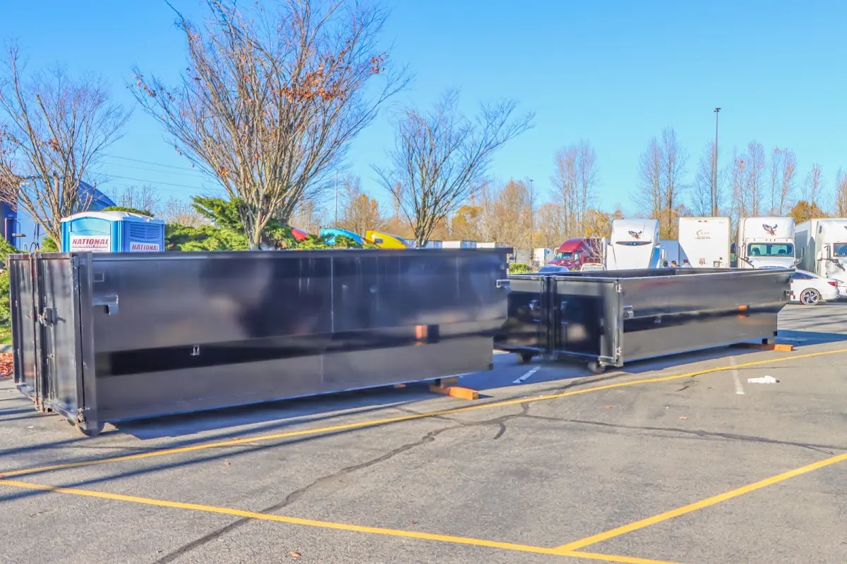 Professional dumpster rental service with roll-off container on residential driveway in Oakleaf Plantation